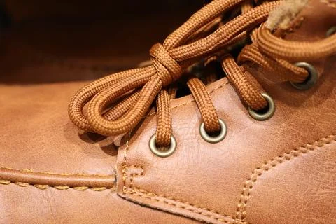 Stylish Brown Leather Boot featuring Laces, Eyelets, and a Classic Chic Design Stock Photos