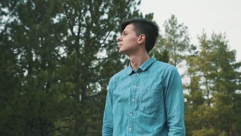 Stylish brunet man standing in forest being shot from 180 degrees in slow motion 스톡 동영상 105286572
