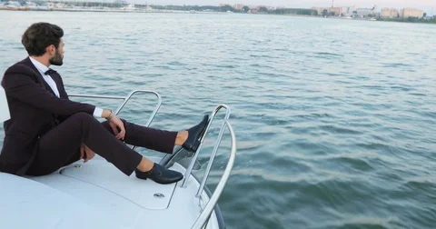 Stylish businessman on a yacht or boat against a sea. transport, business trip Stock Footage