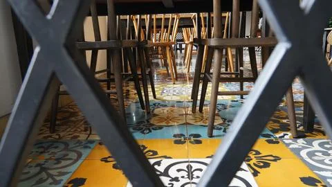 Stylish Cafe Interior with Patterned Tile Floor and Wooden Chair Foto stock