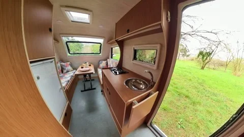 A stylish caravan video with a kitchen, seating area, and beds. Video stock 242455293