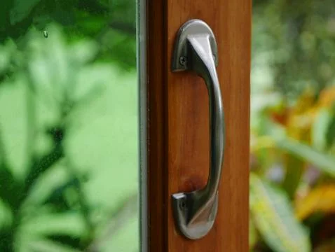 Stylish chrome handle on a window frame, handle on the door Stock Illustration