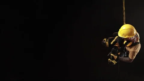 Stylish climber Builder hands and works with the tool. black background. copy Stock Footage 99024272