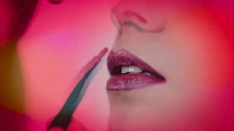 Stylish Close Shot of Makeup Applying Brush Lipstick on Girl's Lips Stock Footage 129385025