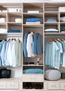Stylish clothes, shoes and home stuff in large wardrobe closet Stock Photos