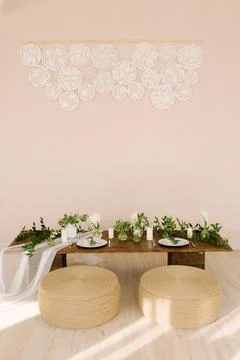 Stylish coffee table with ottomans in the style of boho or rustic in the hous Stock Photos
