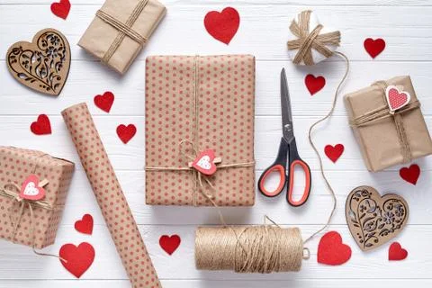 Stylish composition with gift, scissors, wrapping paper and twine. Packaging of Stock Photos