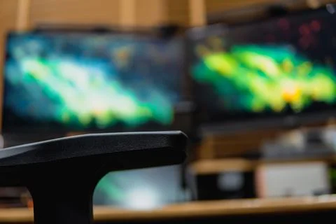 Stylish computer desk setup with dual monitors, a microphone. Stock Photos