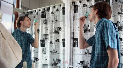 Stylish confident young man looking in a mirror and combing his blonde hair Stock Footage 51677185