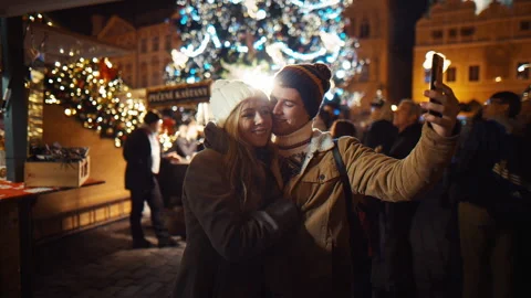 Stylish couple makes a video call and takes a selfie in the middle of the street Stock Footage 220689328