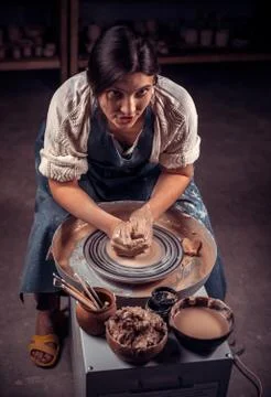 Stylish craftsman master posing while making earthenware. Craft manufacture. Foto stock