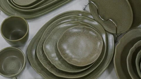 Stylish Dark Green Set of Dinnerware Arranged on Display in Store Stock Footage 321768981