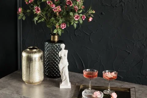 Stylish dark interior featuring a decorative table with a vase of flowers, a Stock Photos