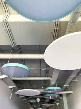 Stylish decorated ceiling with circular hanging elements in a modern interior Stock Photos
