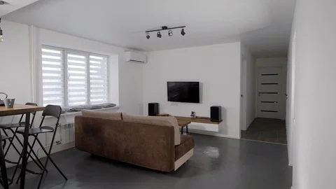 Stylish design of modern studio apartment with living room, no people, panoramic Stock Footage 124516443