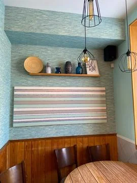 Stylish dining area with modern decorative elements and hanging lights. the h Stock Photos