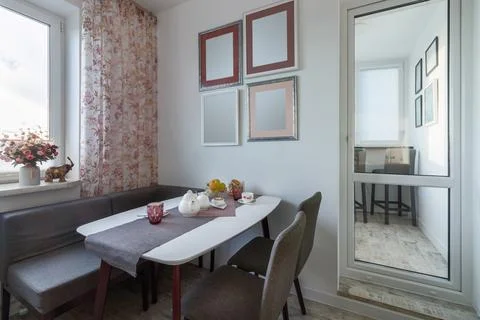 Stylish dining room interior design with dining table. Creative walls, white  Stock Photos