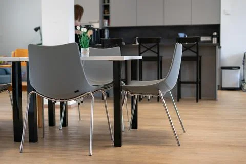 Stylish dining room interior with table, gray chairs and elegant accessories Stock Photos