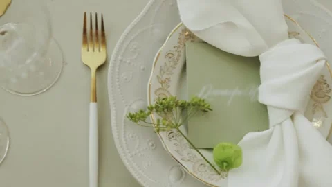 Stylish dining table setting with a gold plate and elegant napkin at a wedding Stock Footage 306156540