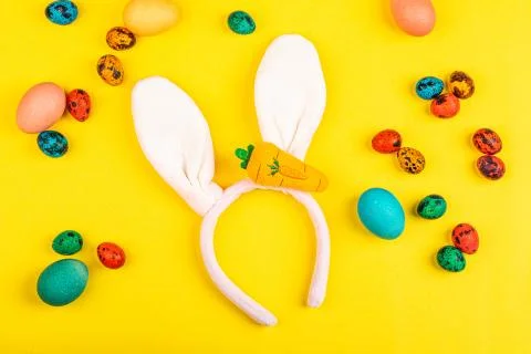 Stylish easter background with rabbit ears and colorful eggs. Flat lay, top v Stock Photos