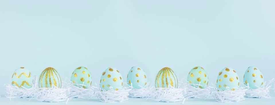 Stylish easter banner - blue easter eggs with gold design in white nest in ro Stock Photos