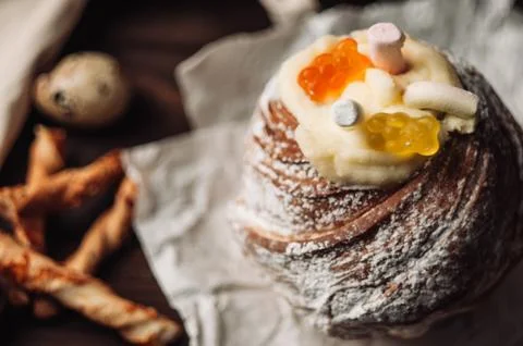 Stylish Easter cake with marshmallows and jelly bears on a dark rustic wooden Stock Photos