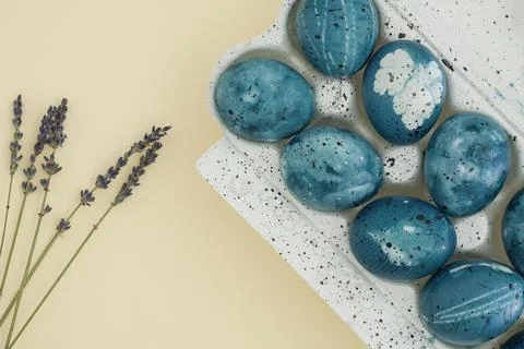 Stylish easter composition on a trendy yellow background of lavender branches Stock Photos