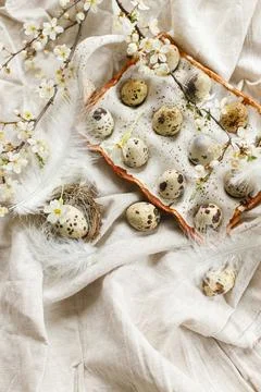 Stylish easter eggs and blooming spring flowers on linen fabric. Happy East.. Stock Photos