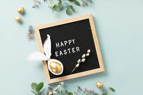 Stylish Easter flat lay with letter board, egg in easter bunny napkin, gold.. Stock Photos