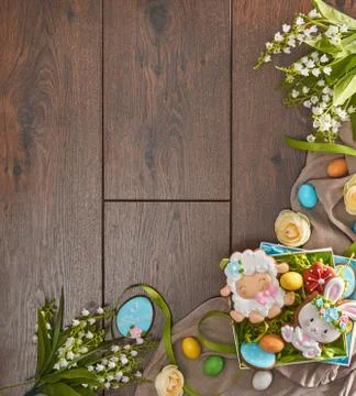 Stylish easter frame made of gingerbread, eggs and flowers Stock Photos