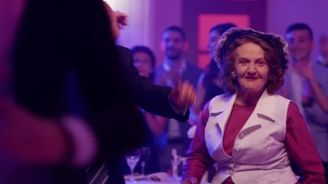 Stylish elderly couple having fun dancing at a colorful party . Stock Footage 123728166