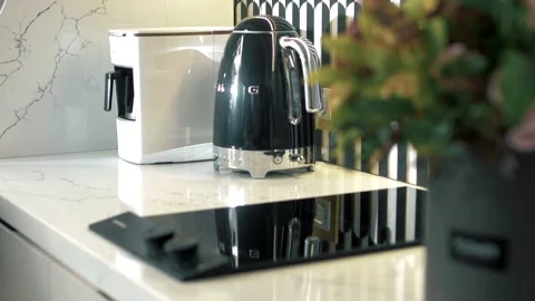 Stylish electric kettle in a modern kitchen with plants. Stock Footage 165988024