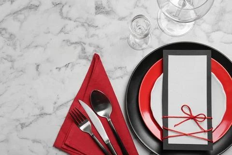 Stylish elegant table setting and blank card on marble background, top view.  Stock Photos