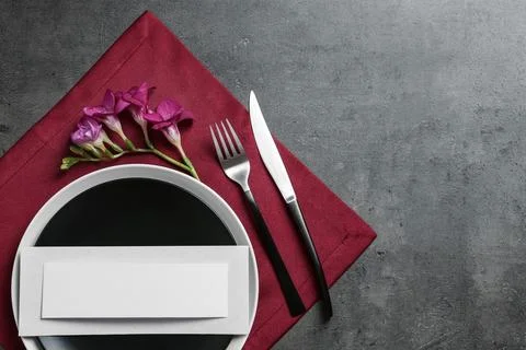 Stylish elegant table setting and blank card on color background, top view. S Stock Photos