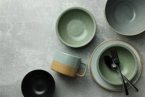 Stylish empty dishware and cutlery on light grey table, flat lay Stockfoto's