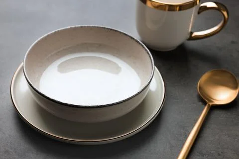 Stylish empty dishware and spoon on grey table, closeup Stock Photos