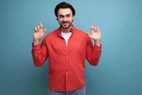 Stylish european 35 year old man in casual shirt points finger to the side Stock Photos