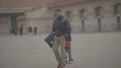 A stylish father and son walking in a square in Madrid, Spain Stock Footage 345027796