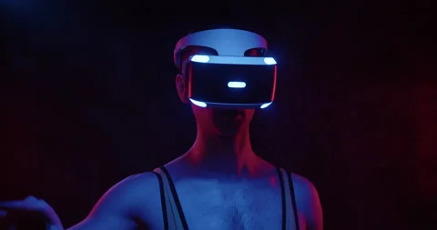 Stylish future handsome young man gamer wearing VR headset on black background Stock Footage 176021641