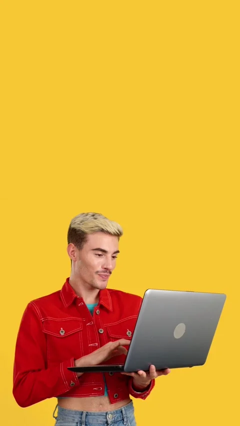 Stylish gay man smiling while using a laptop Видео 252485652