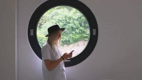 Stylish girl in the loft is using a smartphone for shopping 5g Stock Footage 111786098