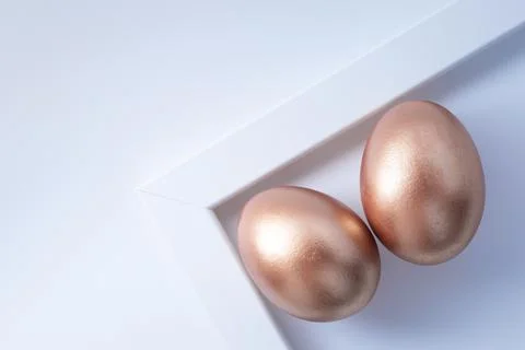 Stylish golden eggs easter concept. Easter gold egg on white background. Flat Stock Photos
