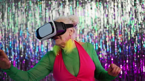Stylish granny in VR headset enjoying vivid virtual reality world, new tech Stock Footage 331216377
