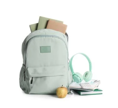 Stylish green school backpack with different stationery supplies, apple and h Stock Photos