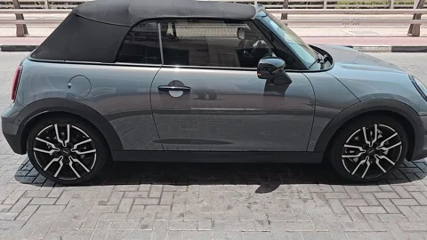 Stylish grey Mini Cooper convertible parked outdoors. Video stock 313358542