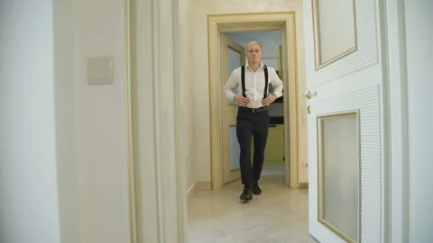 Stylish groom in wedding clothes walks in house. 4K Video stock 86830592