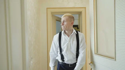 Stylish groom in wedding clothes walks in house. 4K Stock Footage 86830681