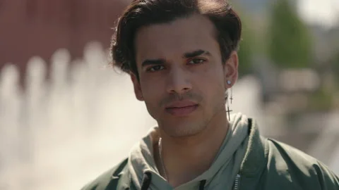 Stylish guy with calm face looking on camera outdoors Video stock 164455268