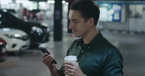 Stylish guy in green shirt using smartphone chatting social media addict. man Stock Footage 246337427