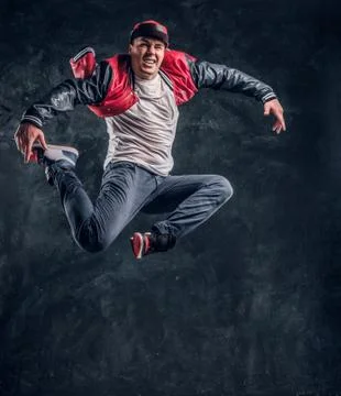Stylish guy performs breakdance acrobatic elements. Stock Photos